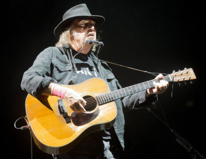 Rock 'n' roll songwriting legend Neil Young performs during an acoustic set on stage on Saturday, July 11, 2015, at Pinnacle Bank Arena. FRANCIS GARDLER/Lincoln Journal Star
